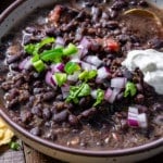 black bean soup in a bowl with toppings