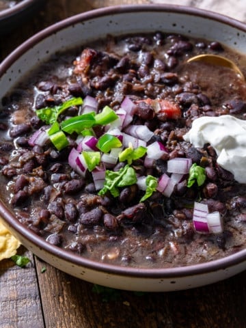 black bean soup in a bowl with toppings