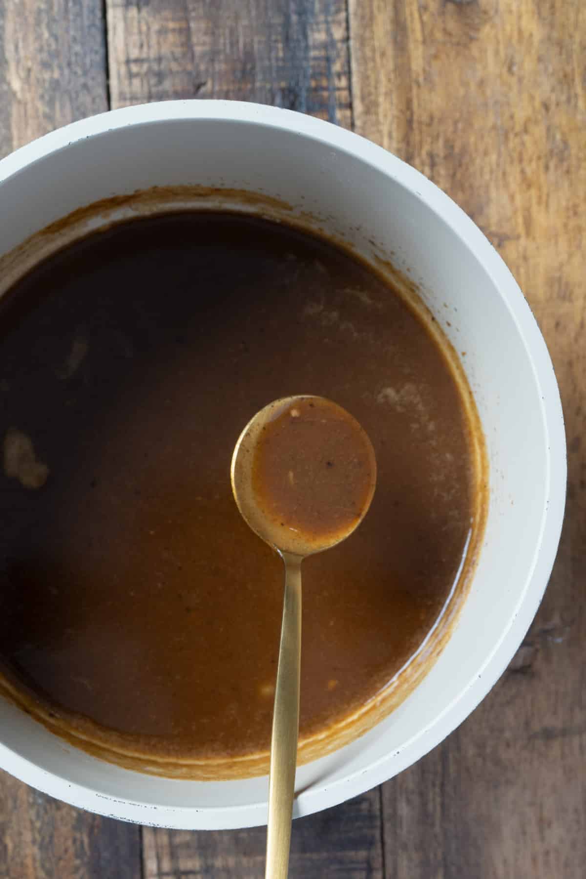 gravy thickened and being held with spoon