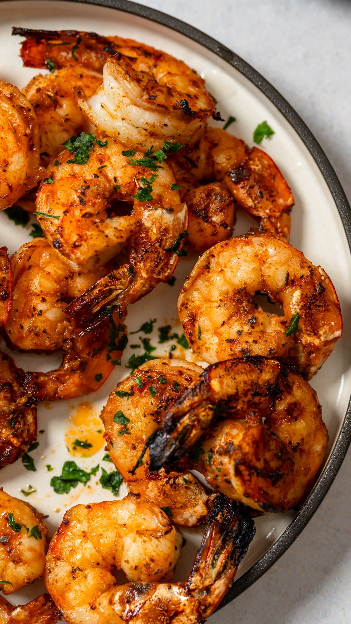 close up of broiled shrimp on plate