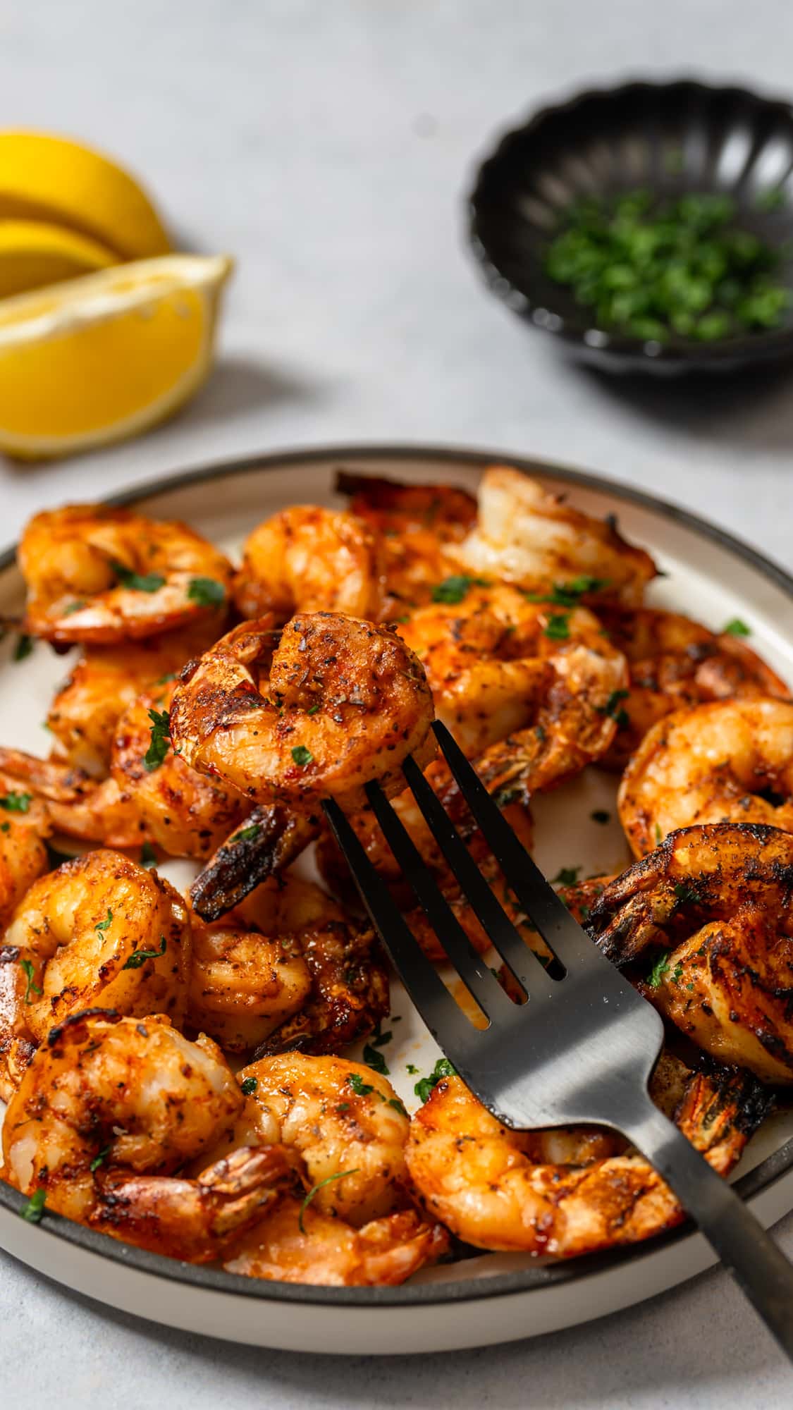 fork picking up broiled shrimp