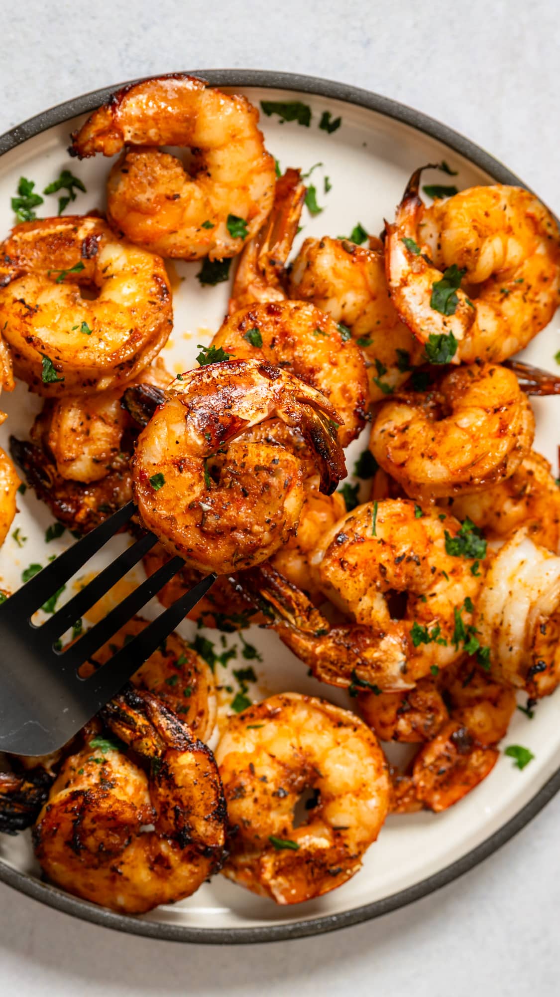 fork picking up broiled shrimp