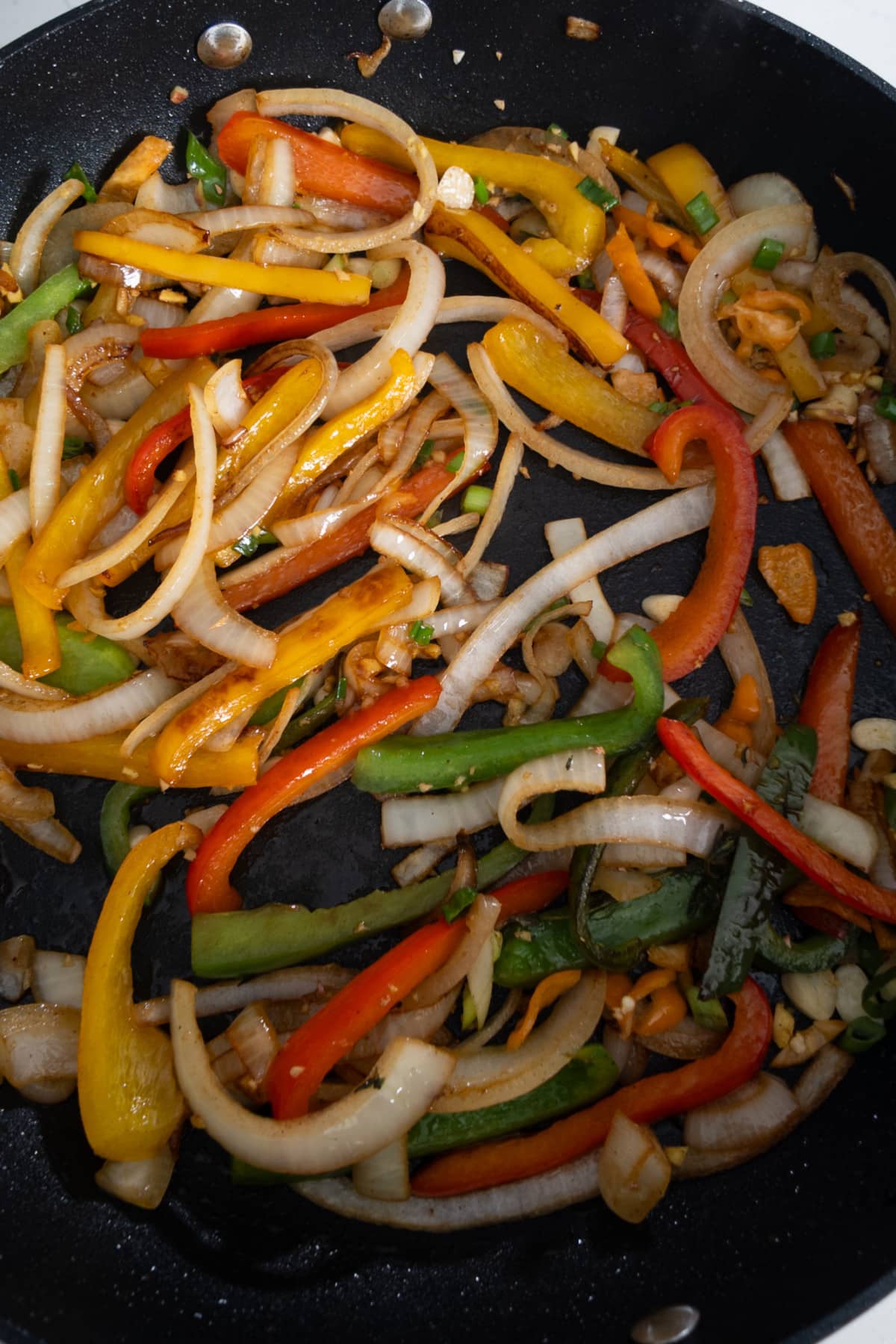 peppers being sauteed in pan