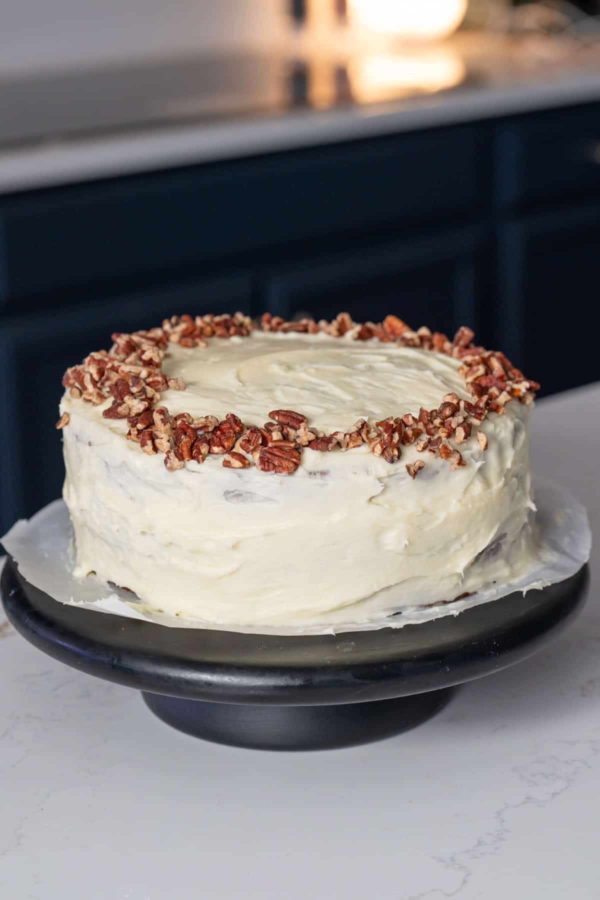 Hummingbird cake on platter on kitchen island