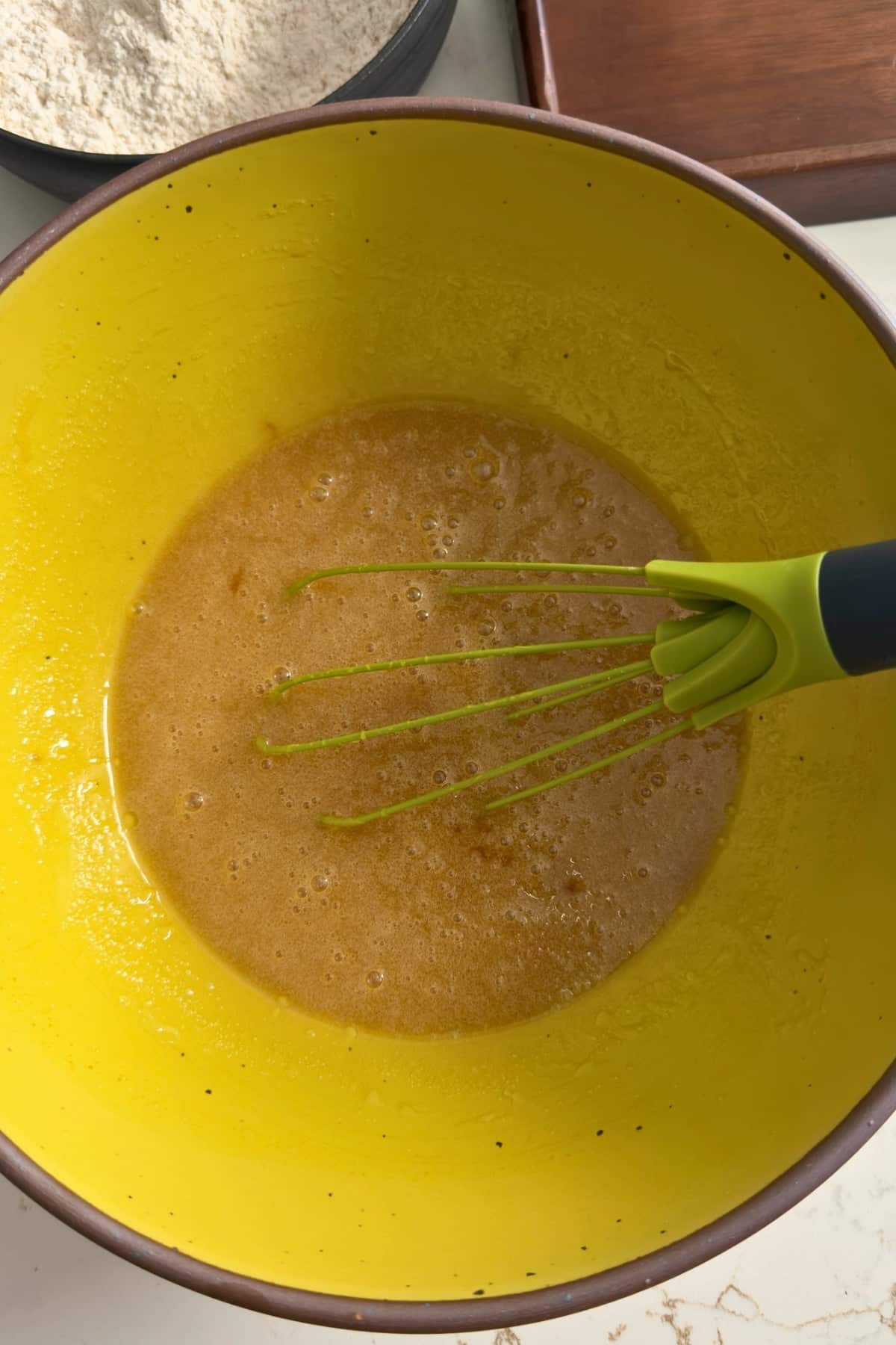Wet ingredients mixed in yellow bowls.