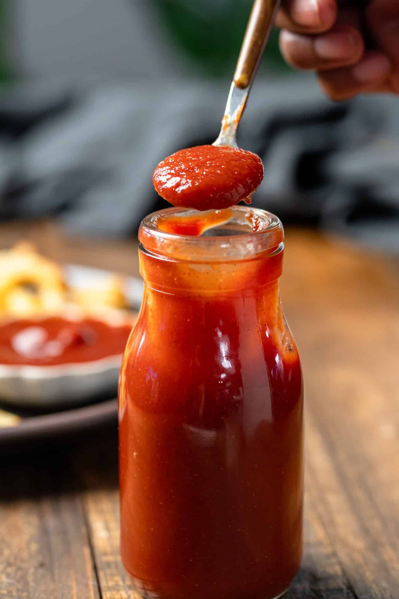 ketchup in bottle being picked up with spoon
