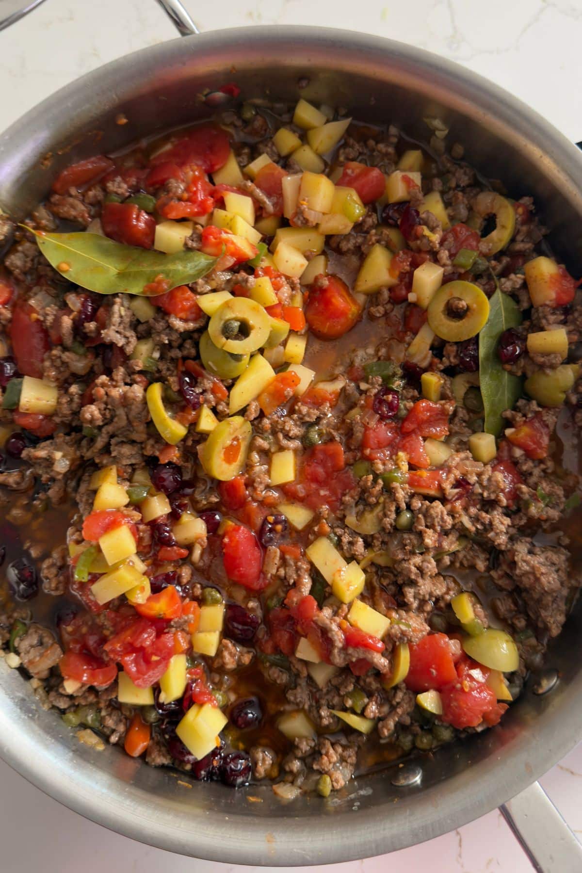Picadillo in skillet before stewing down