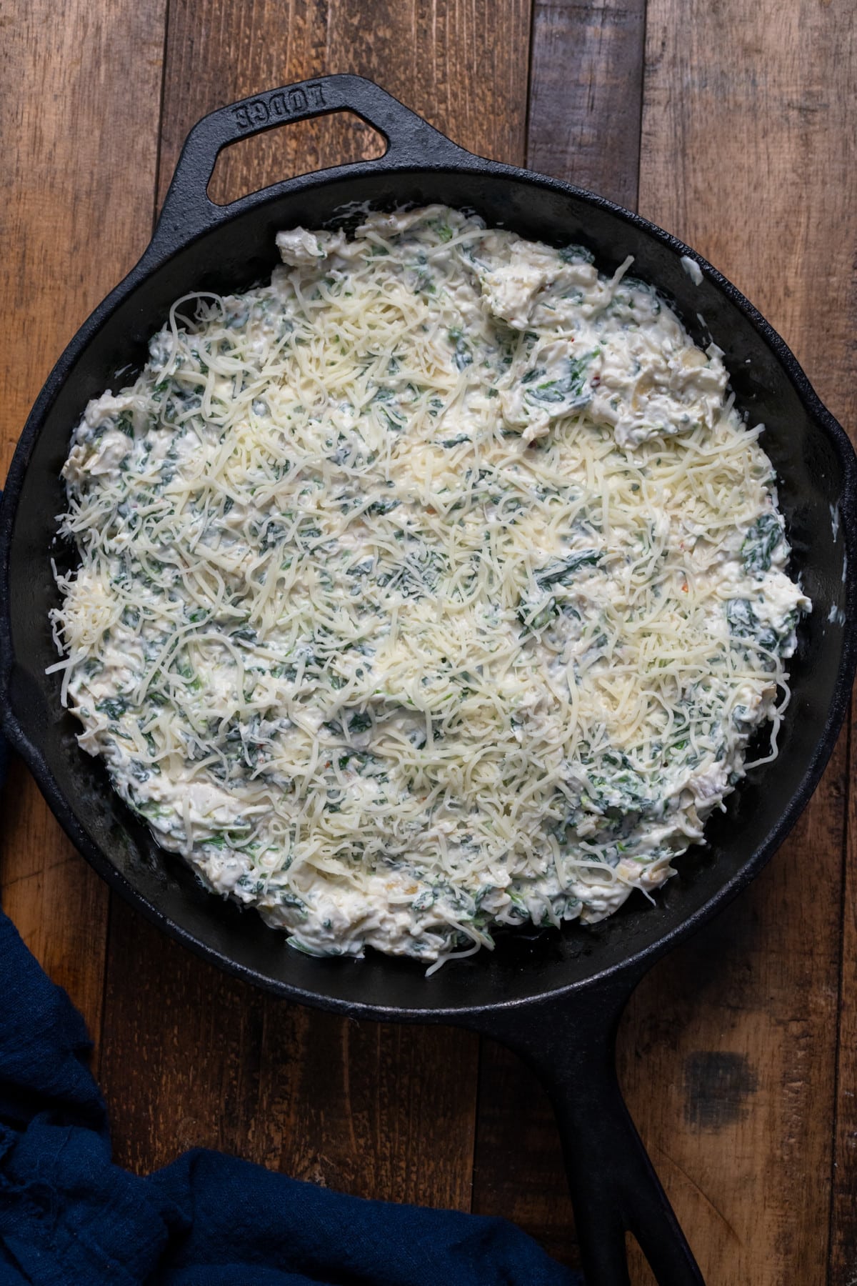 spinach dip in cast iron skillet before baking