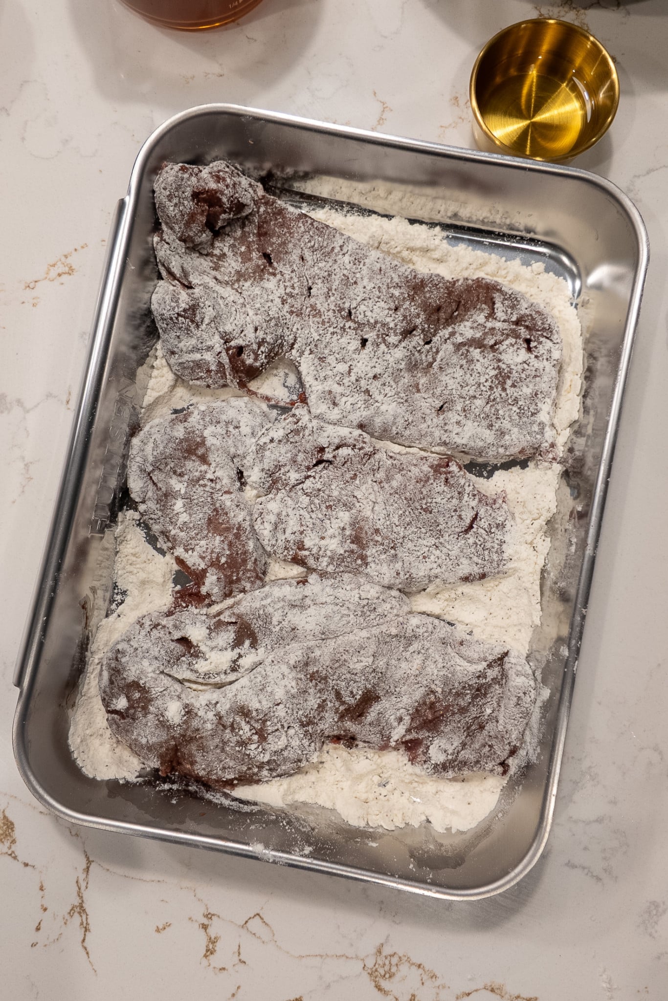 Liver being coated in seasoned flour