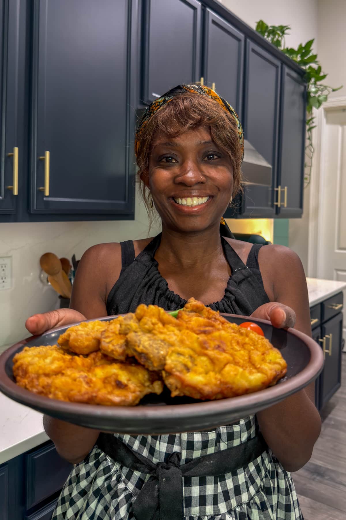Tanya holding a plate of fried pork chops
