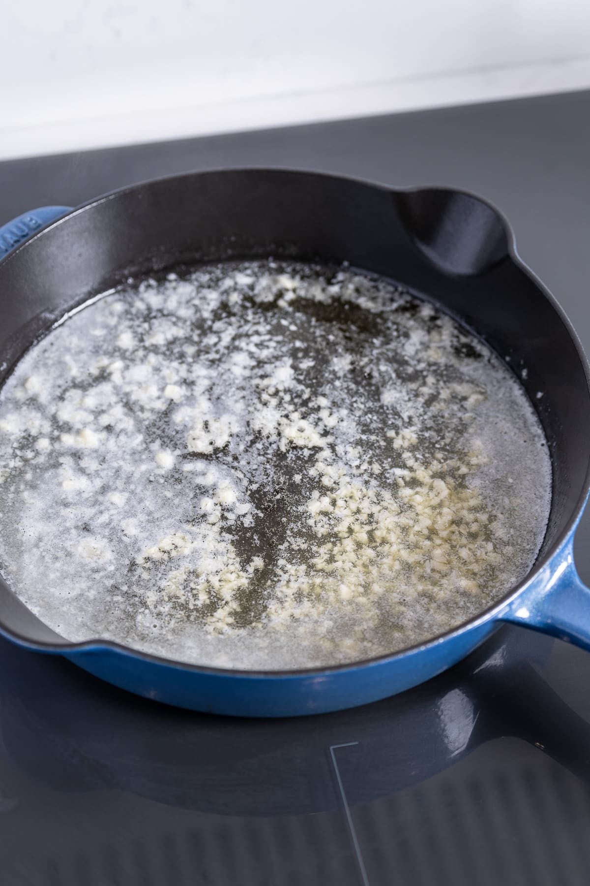 Garlic and butter melting in skillet