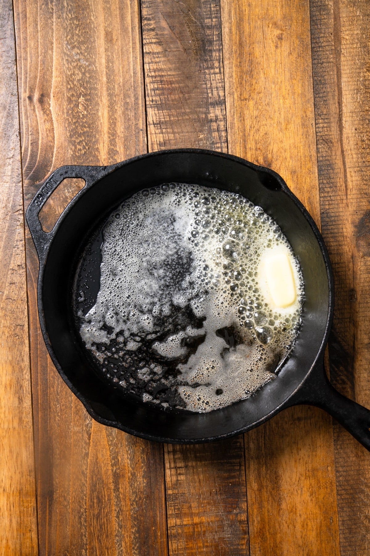 cast iron skillet with melted butter