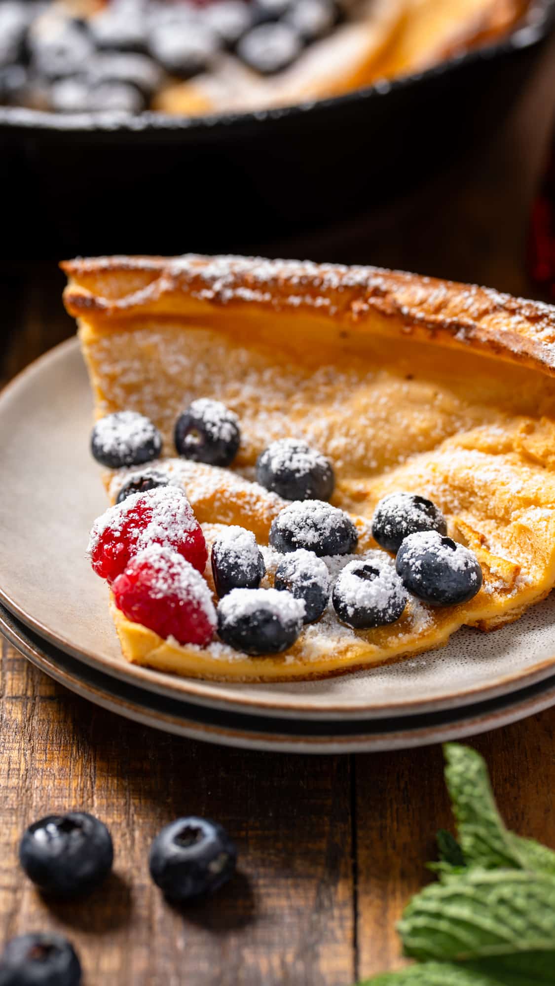 Slice of Dutch baby pancake on a plate.