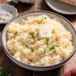 garlic butter rice with butter, head of garlic in background