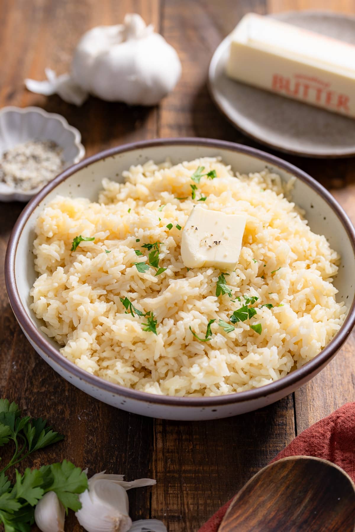 garlic butter rice with butter, head of garlic in background