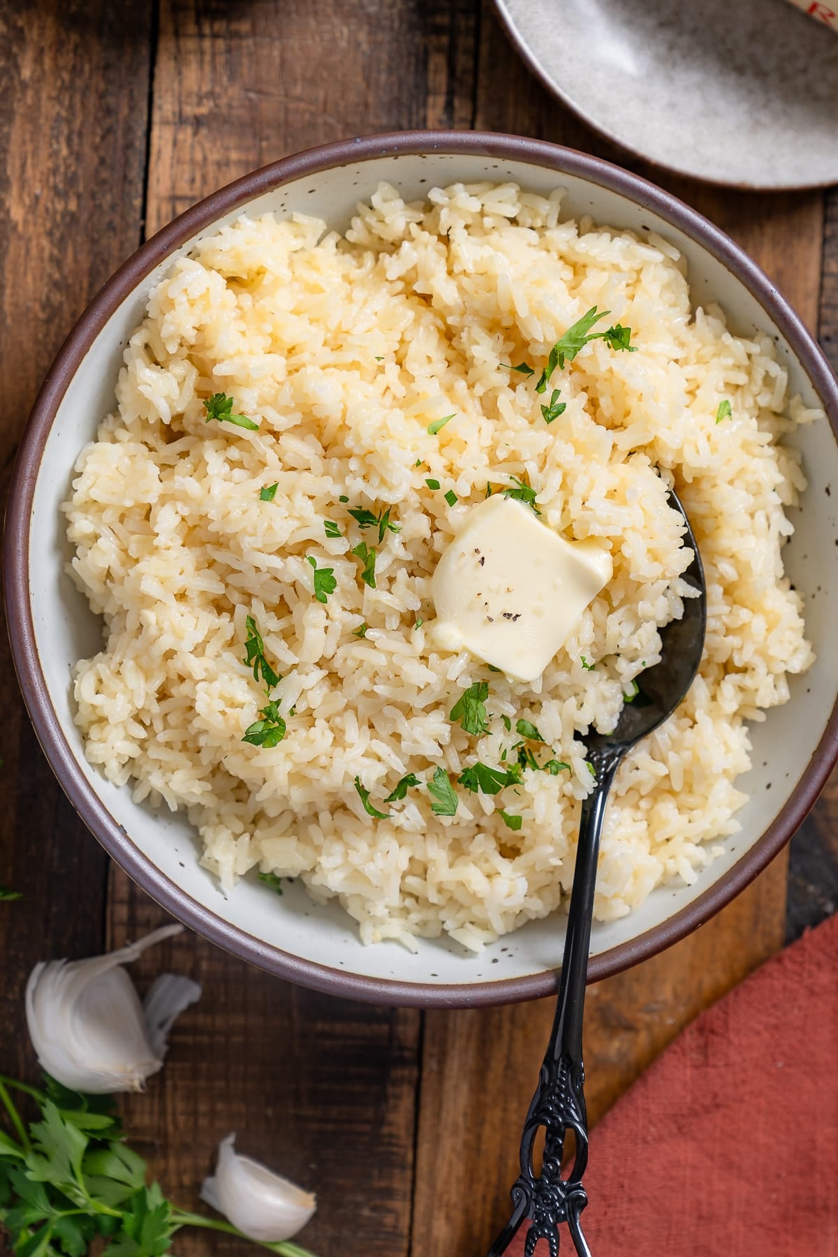 garlic butter rice in bowl wtith spoon sticking out
