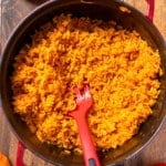 jollof rice in pot surrounded by tomatoes