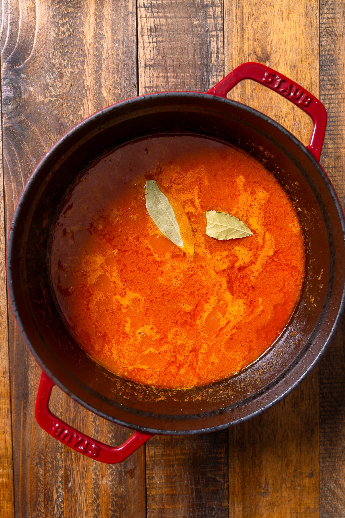all jollof ingredients in pot before steaming rice