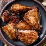 Peruvian chicken pieces cut up on a plate