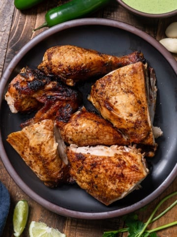 Peruvian chicken pieces cut up on a plate