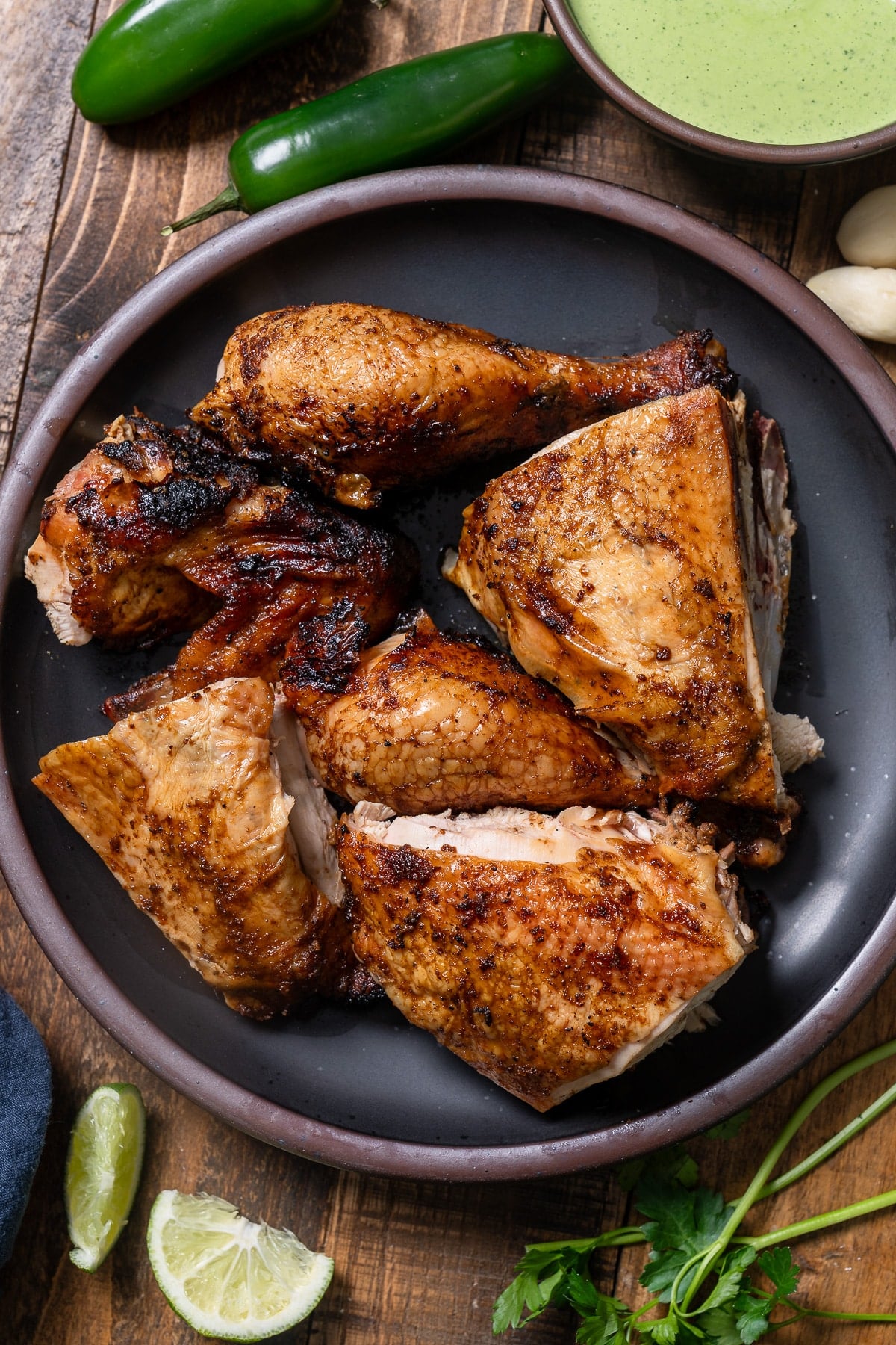 Peruvian chicken pieces cut up on a plate 
