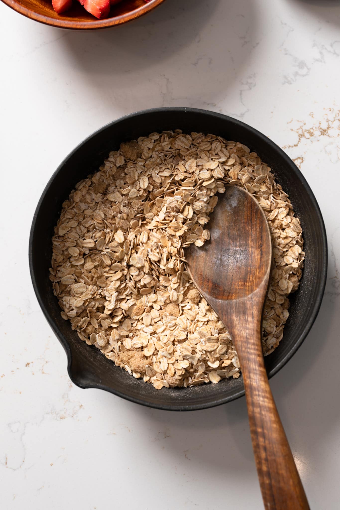 dry oatmeal mixture with a spoon in it.