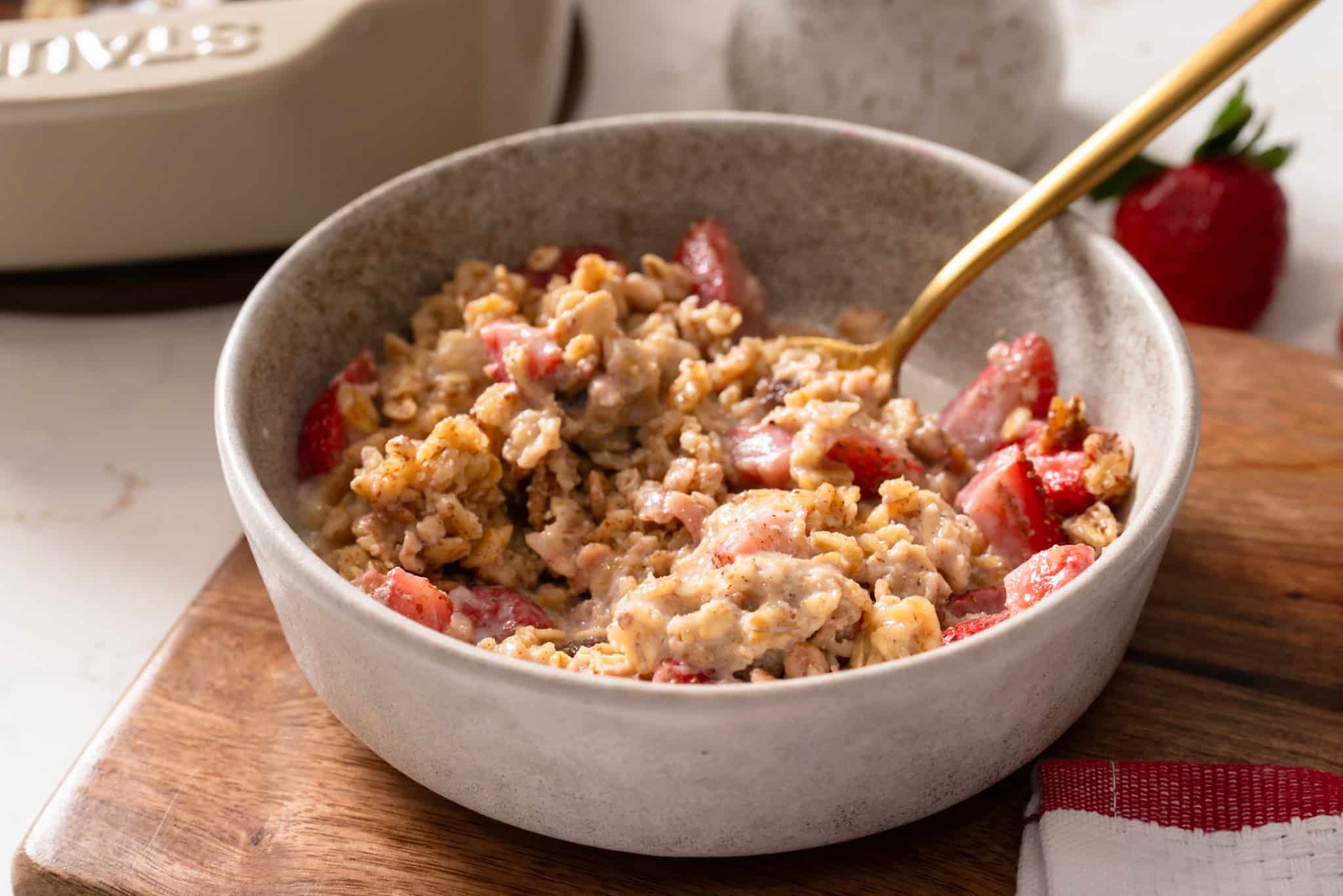 Strawberry baked oatmeal in a bowl with a spoon sticking out