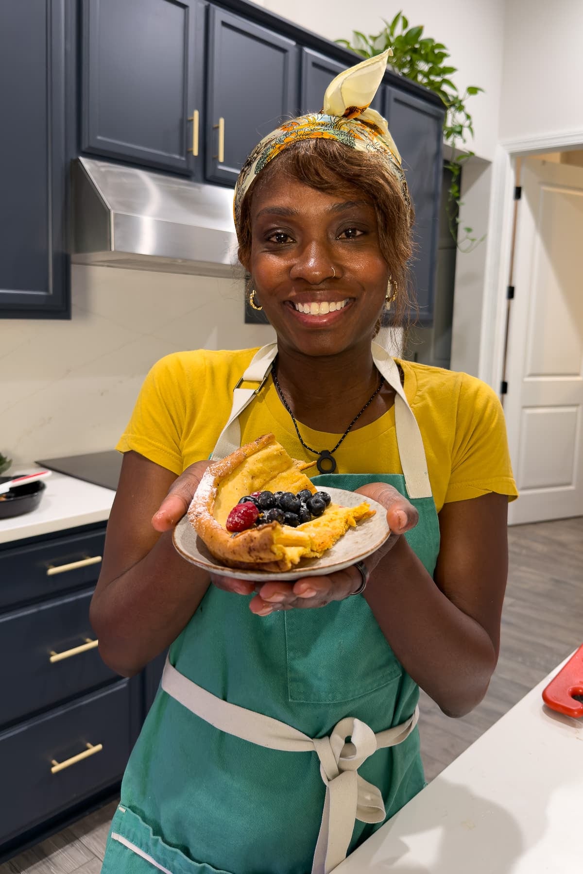 tanya holding a slice of dutch baby pancake