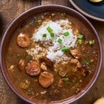 Gumbo in a bowl with green onions on top