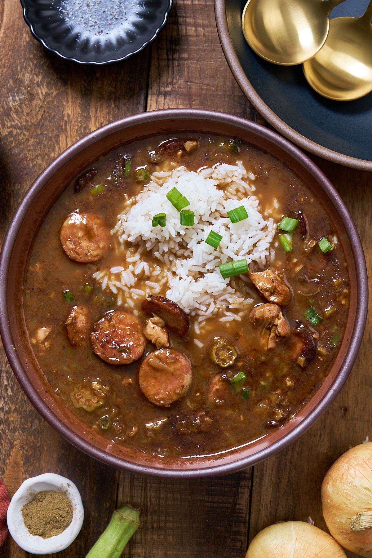 Gumbo in a bowl with green onions on top