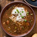 Gumbo in a bowl with green onions on top
