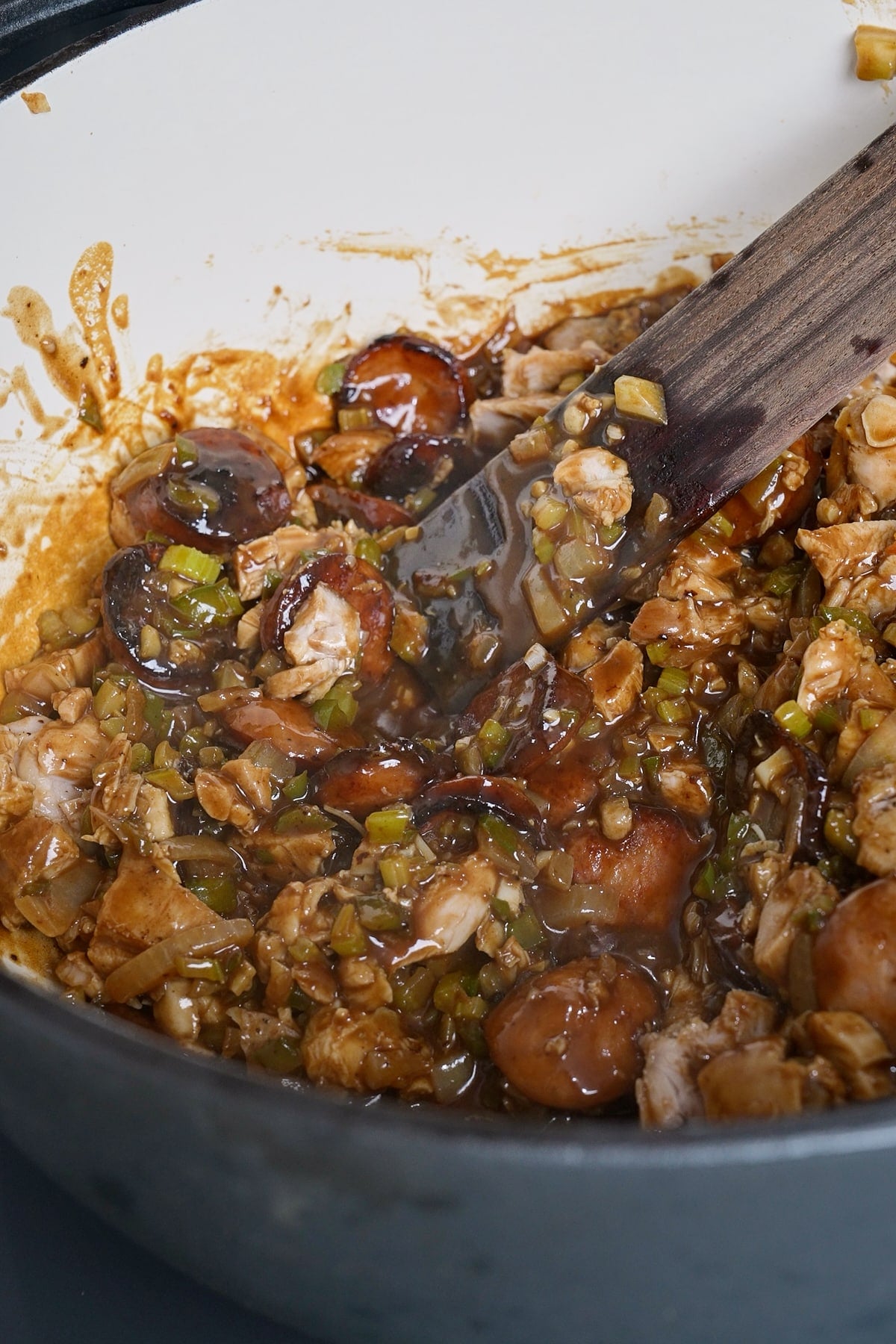 Ingredients for gumbo being mixed with a spatula before broth is added