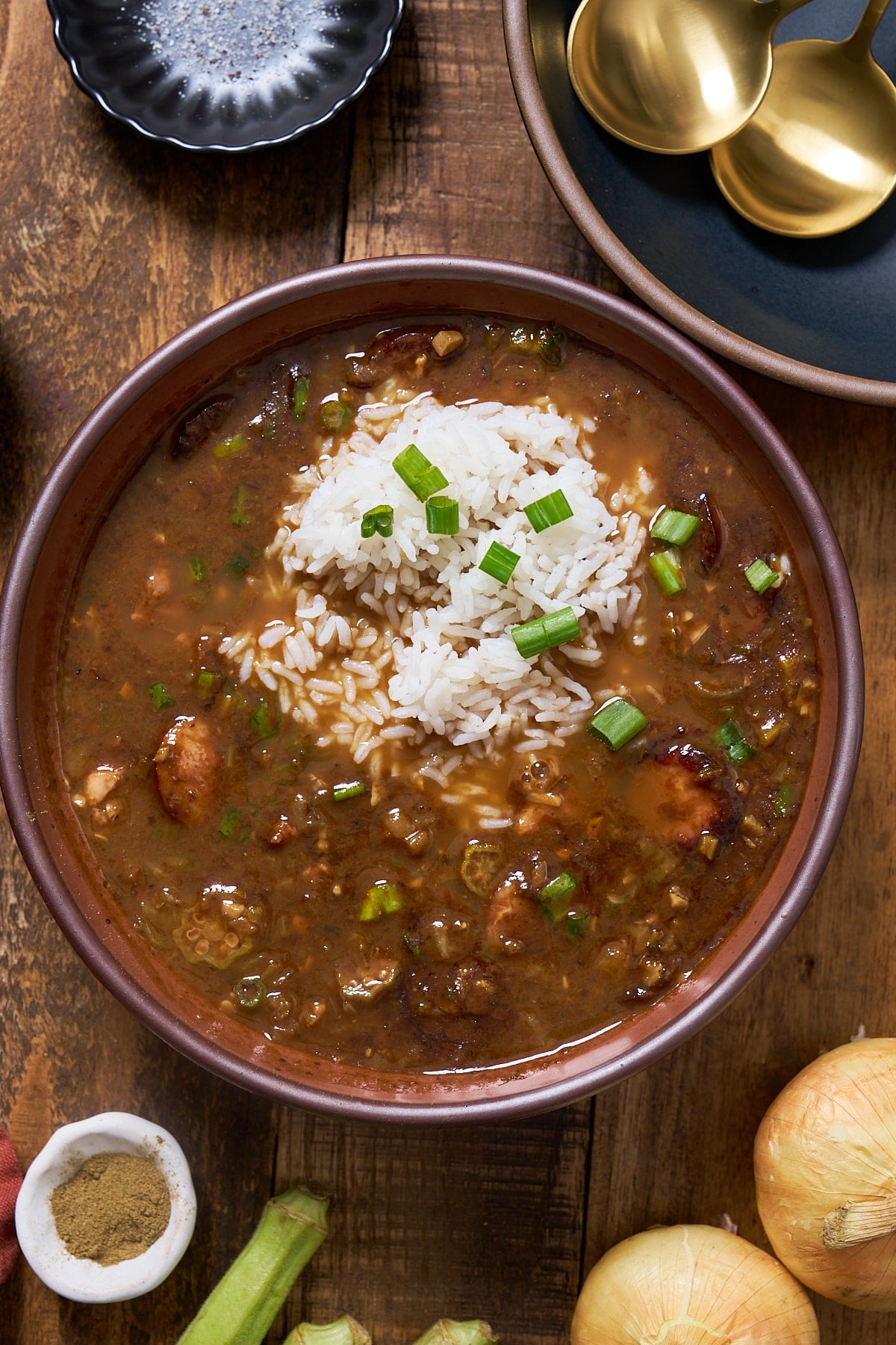 Gumbo in a bowl with green onions on top