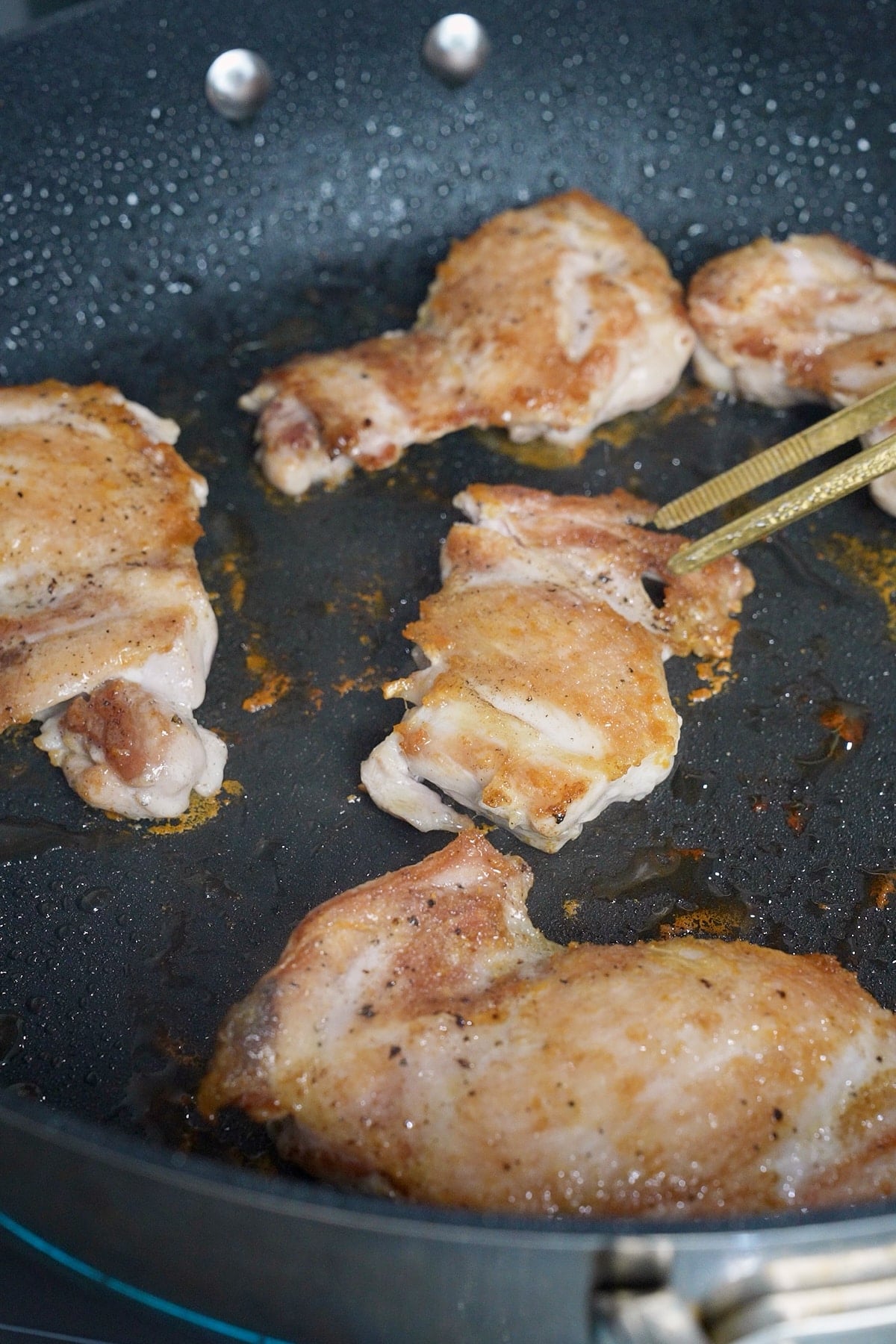 Chicken browning in a skillet