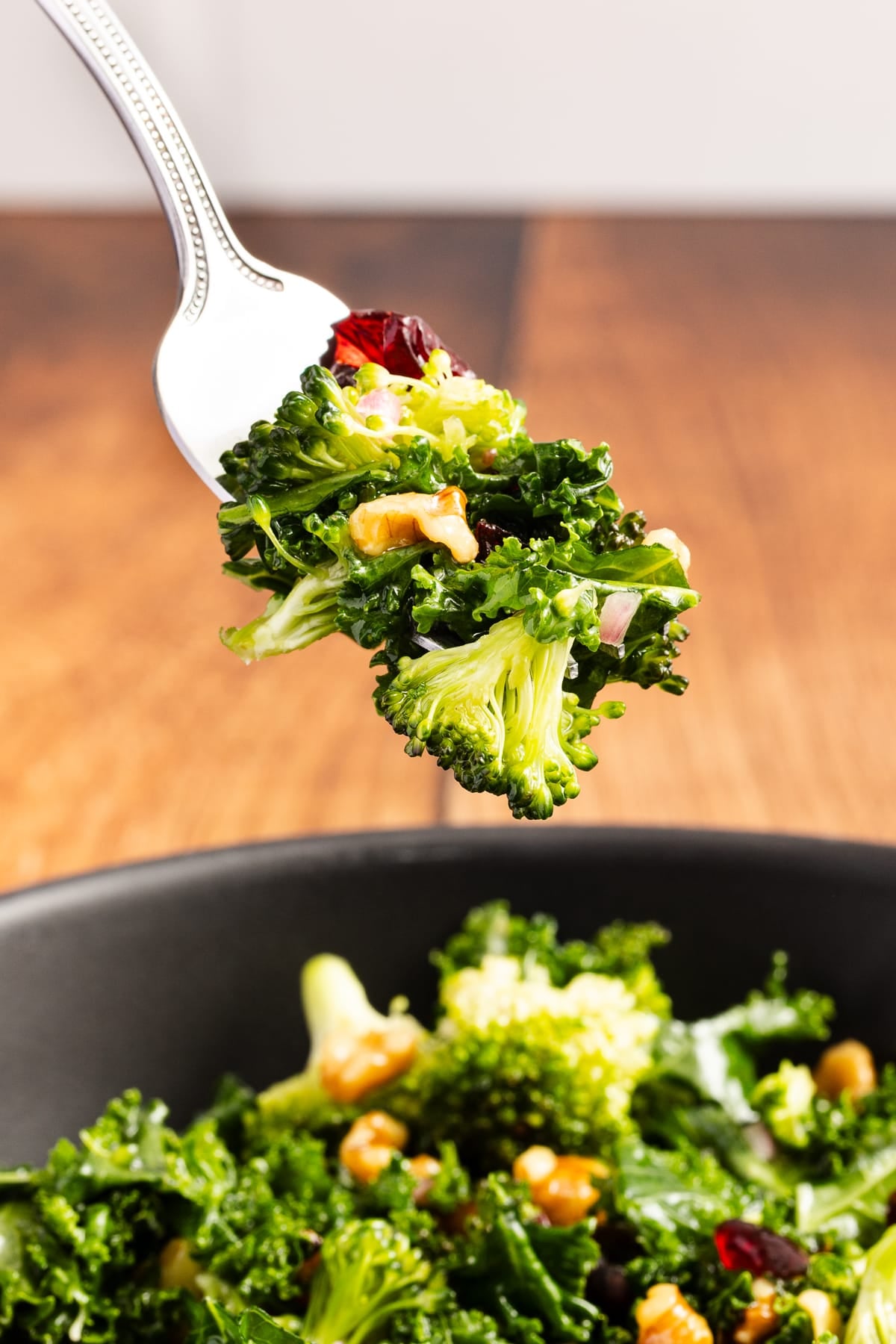 kale and broccoli salad on fork