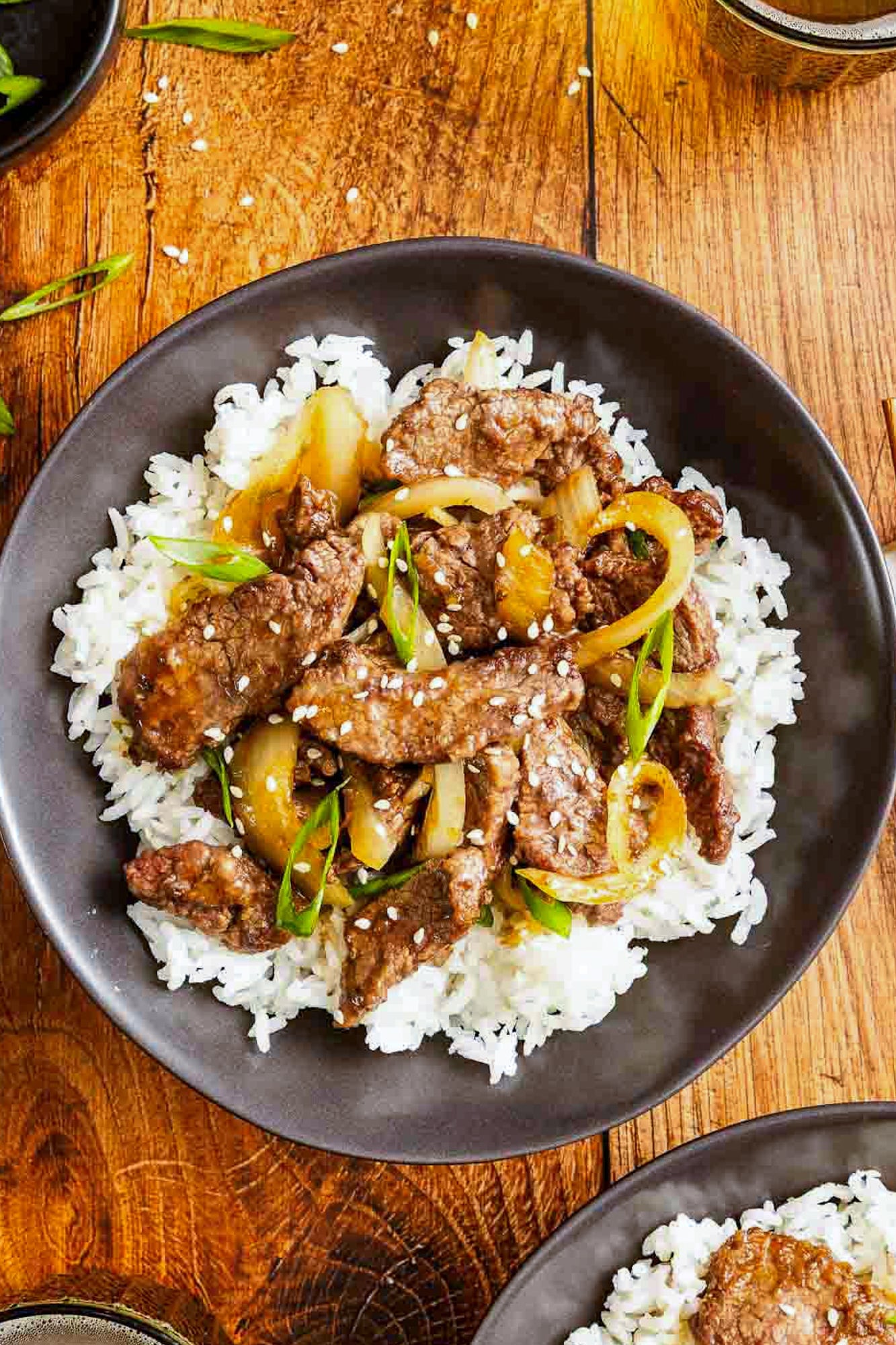 Mongolian beef in a bowl over some rice. 