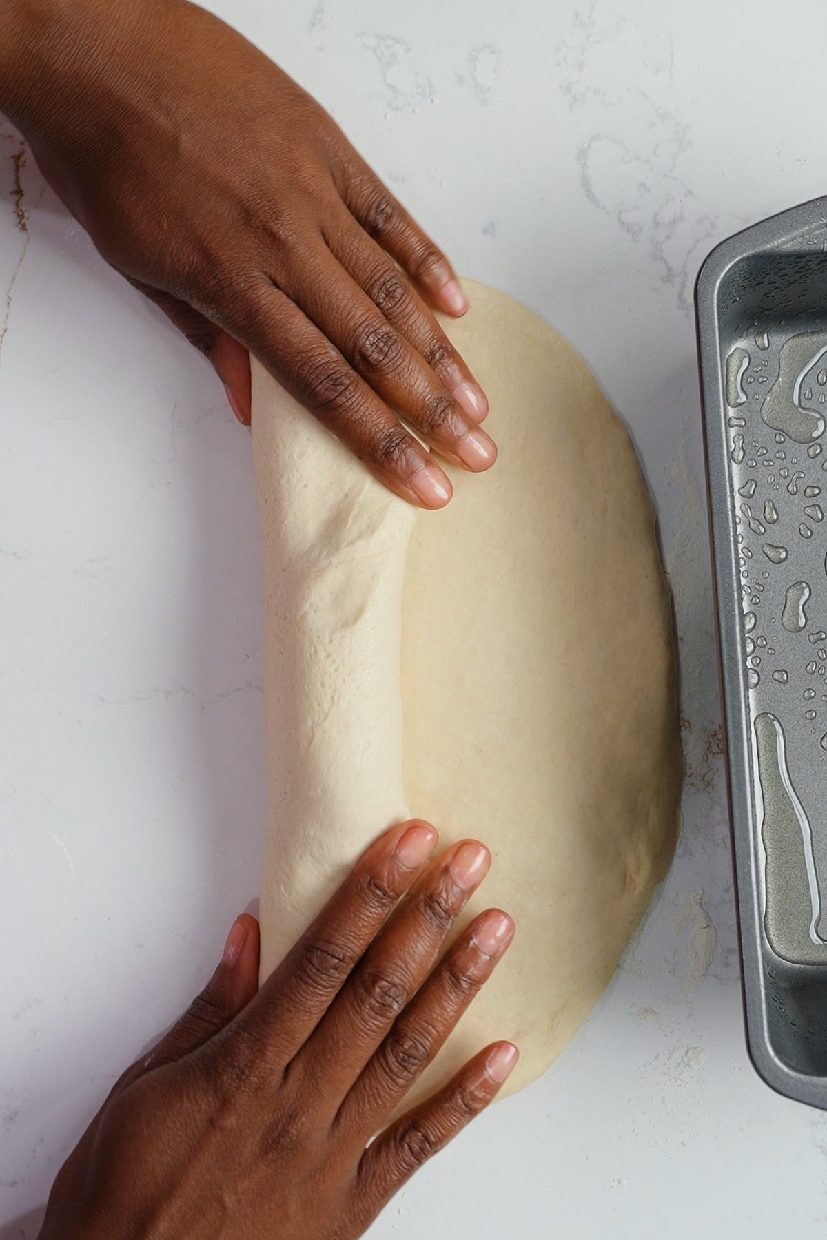 hand rolling dough into log