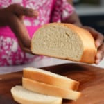 Tanya holding Jamaican hardough bread