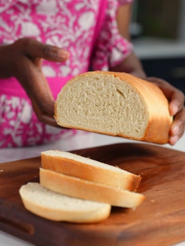 Tanya holding Jamaican hardough bread
