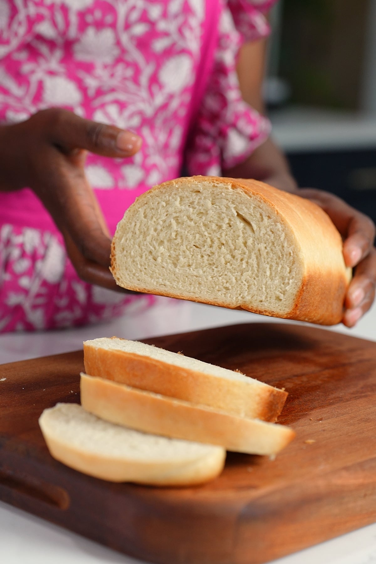 Tanya holding Jamaican hardough bread