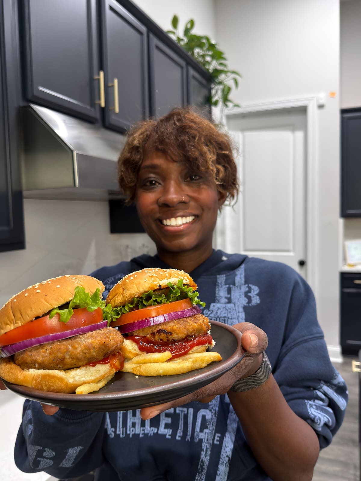 Tanya holding two turkey burgers