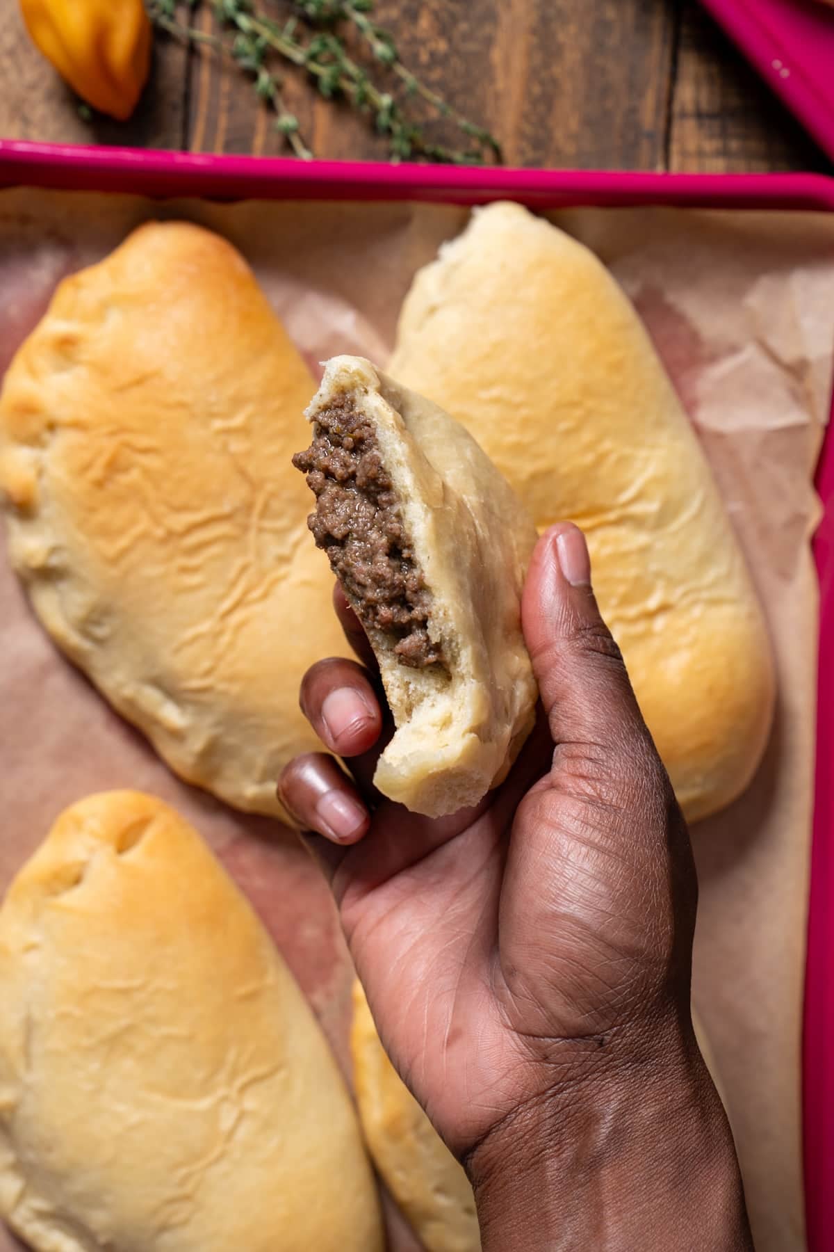 hand holding meatloaf that has been broken in half
