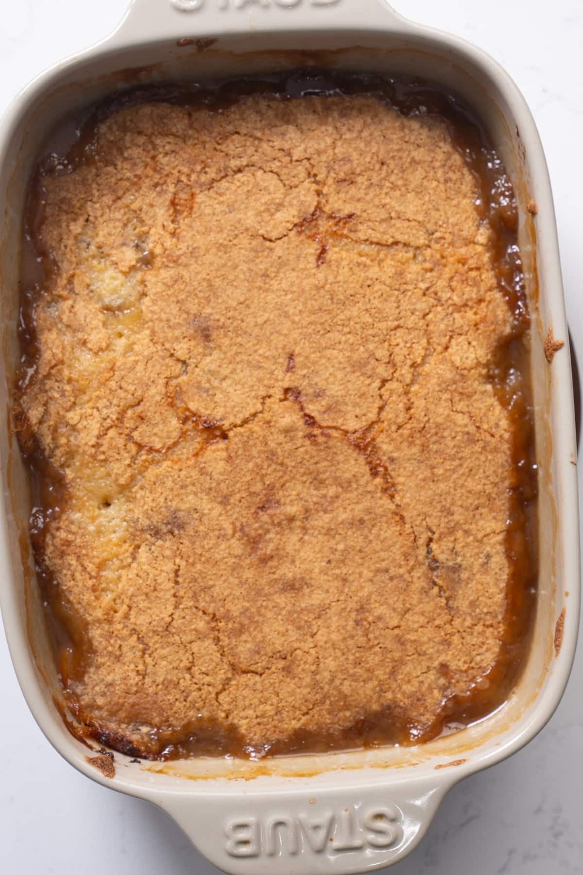 Finished peach cobbler in baking dish