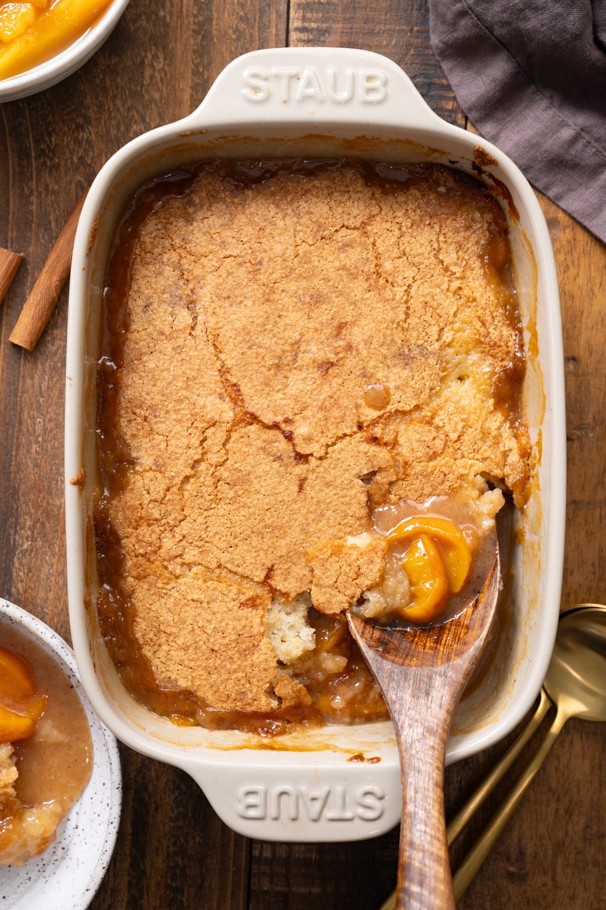 Peach cobbler in baking dish with peaches