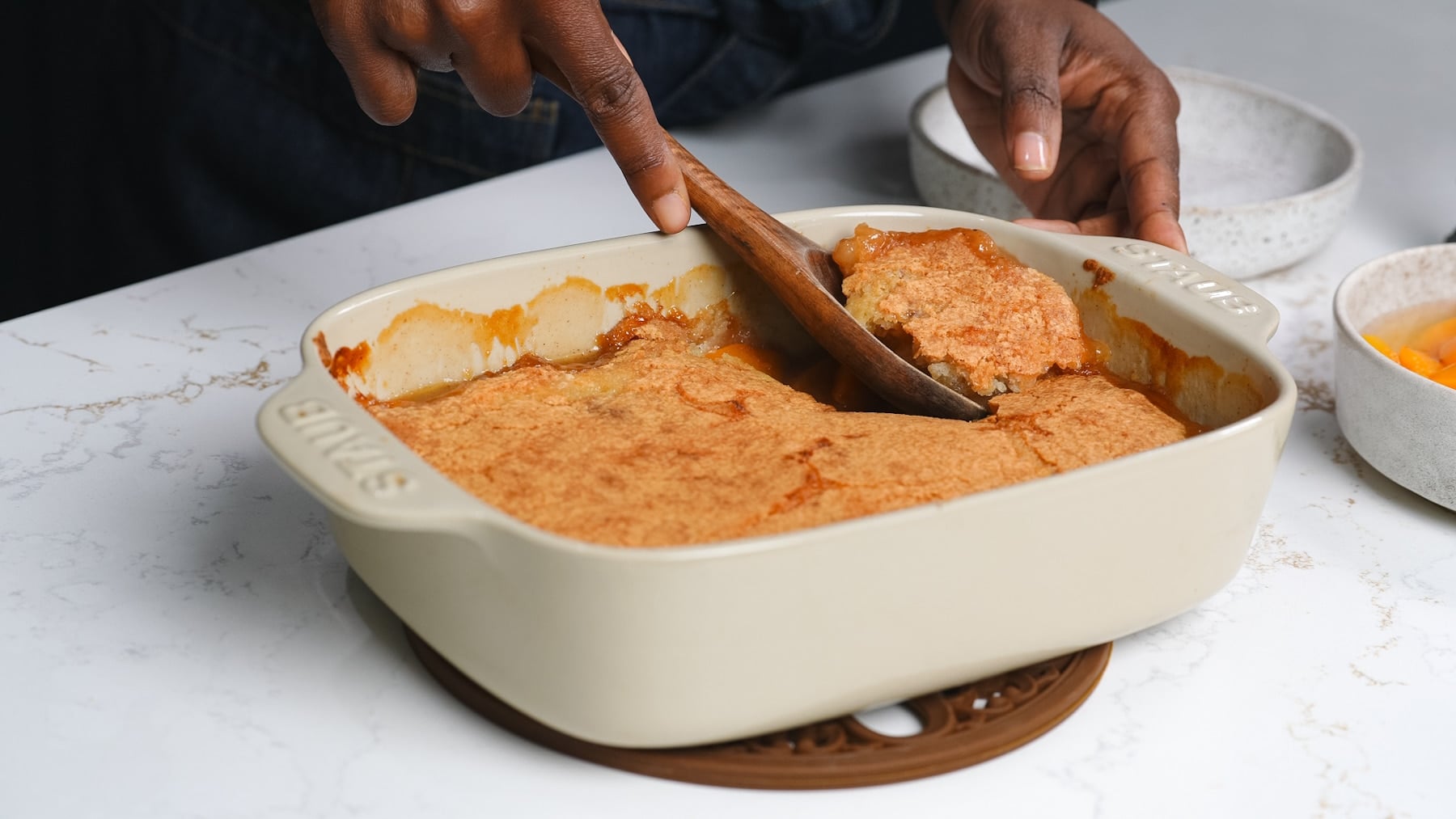 Spoon picking up peach cobbler