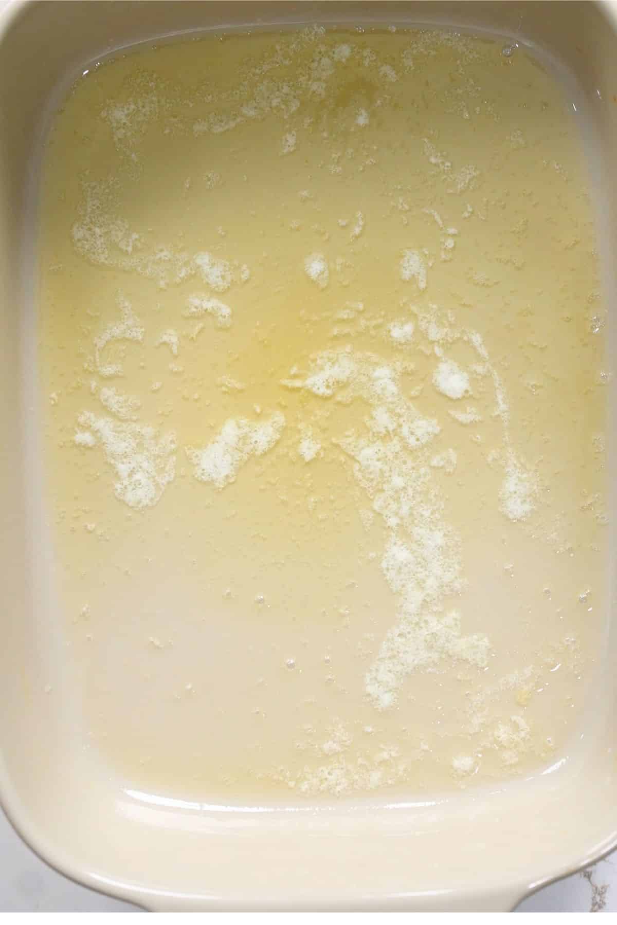 melted butter in baking dish