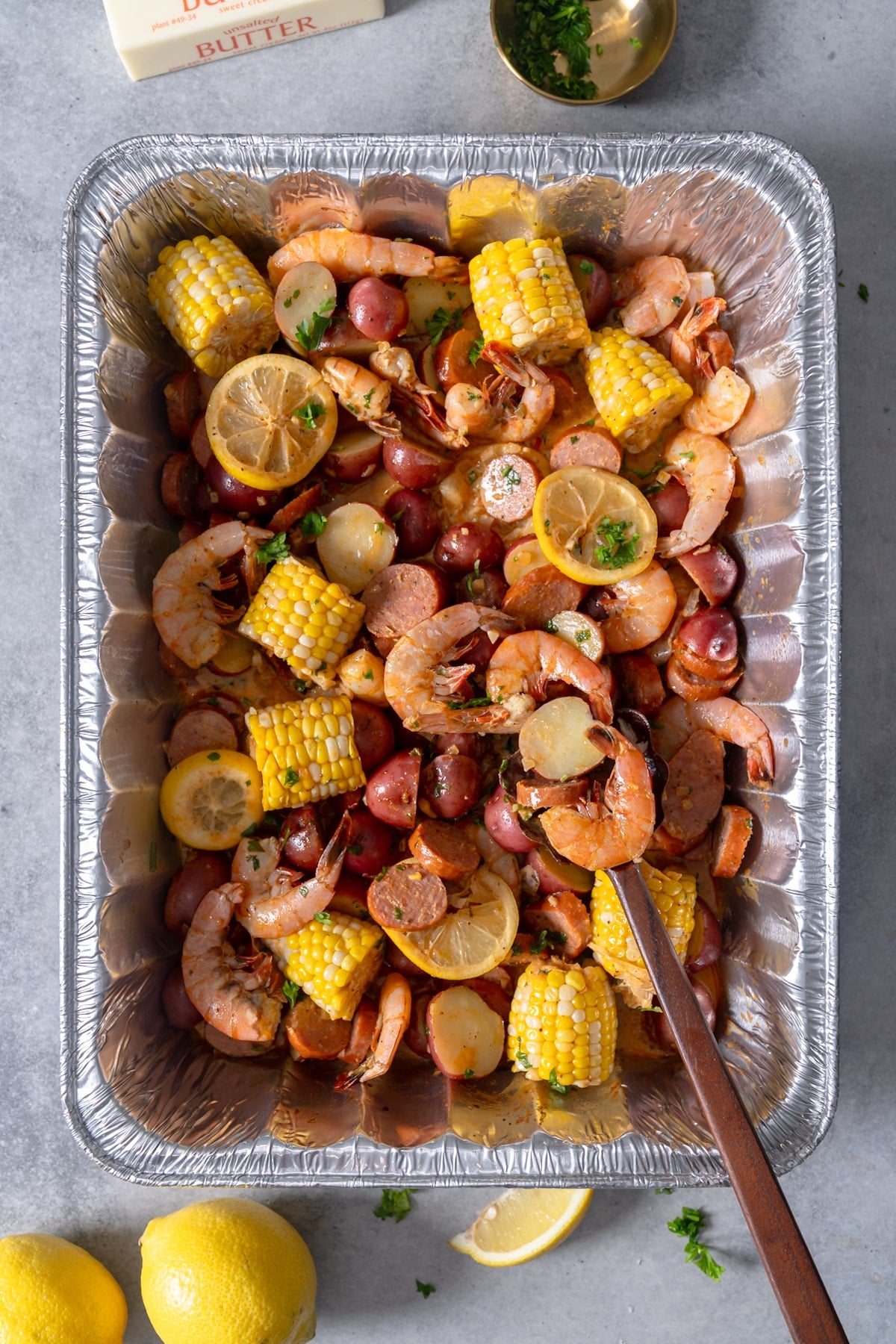 shrimp boil in pan with spoon sticking out