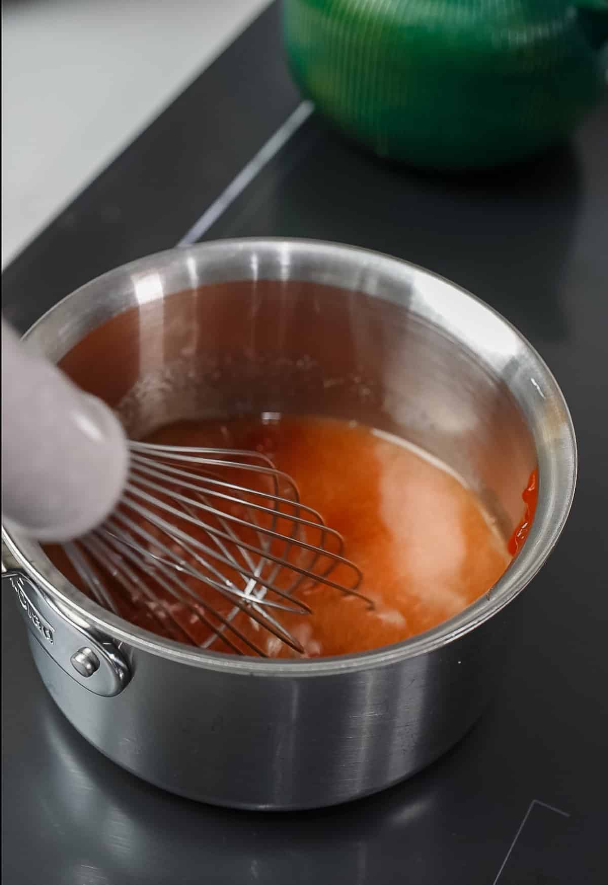whisk stirring ingredients in pot
