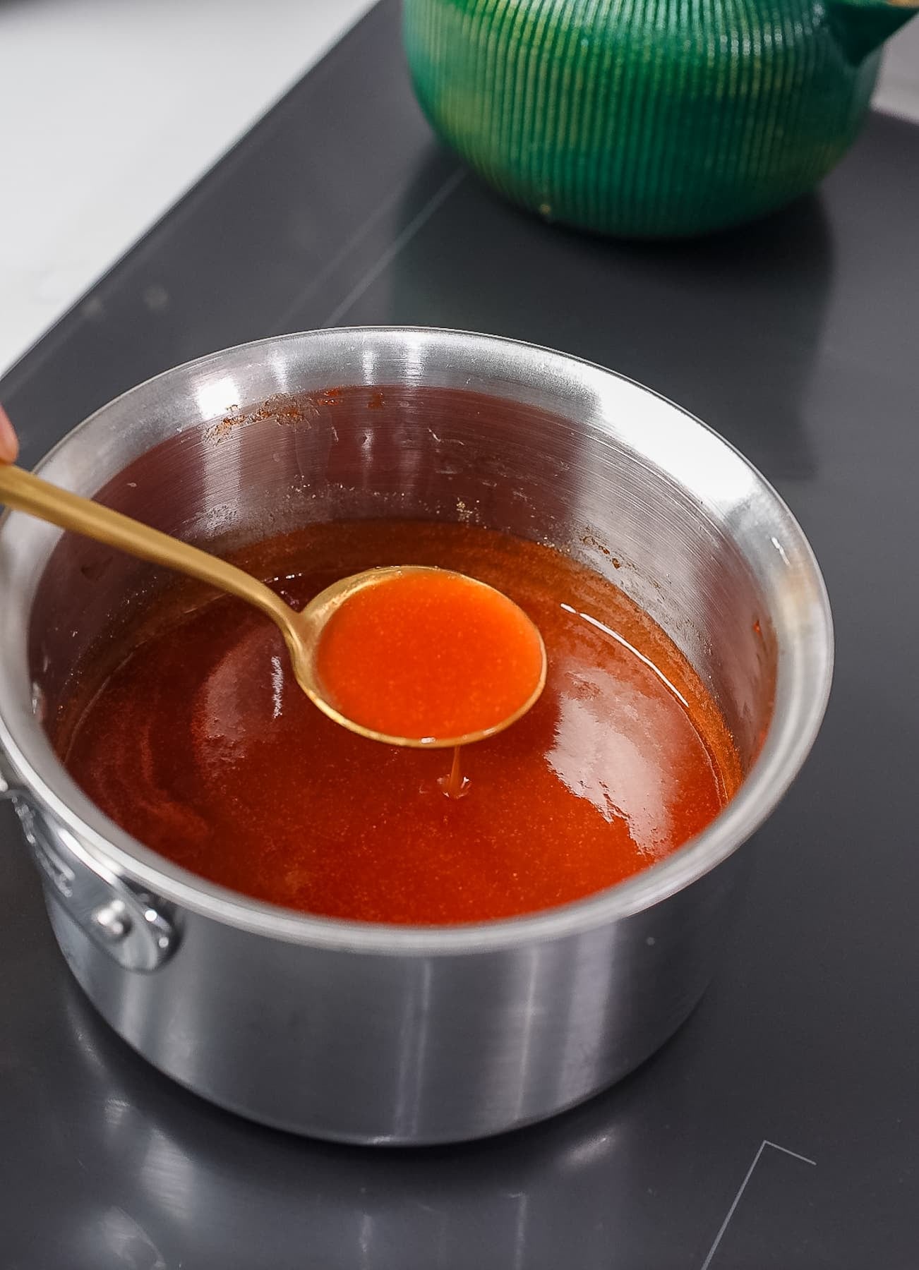 spoon holding up sweet and sour sauce