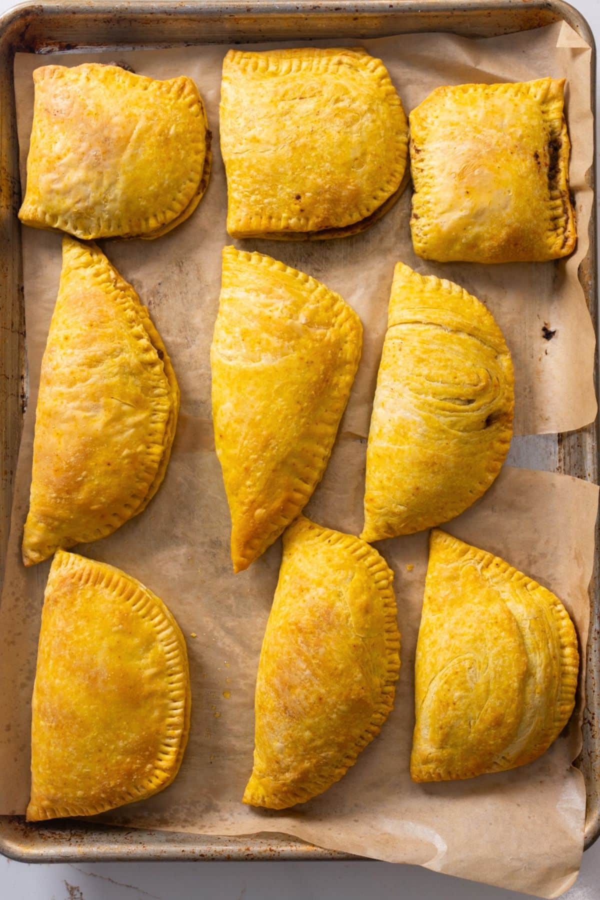 jamaican beef patties on baking sheet